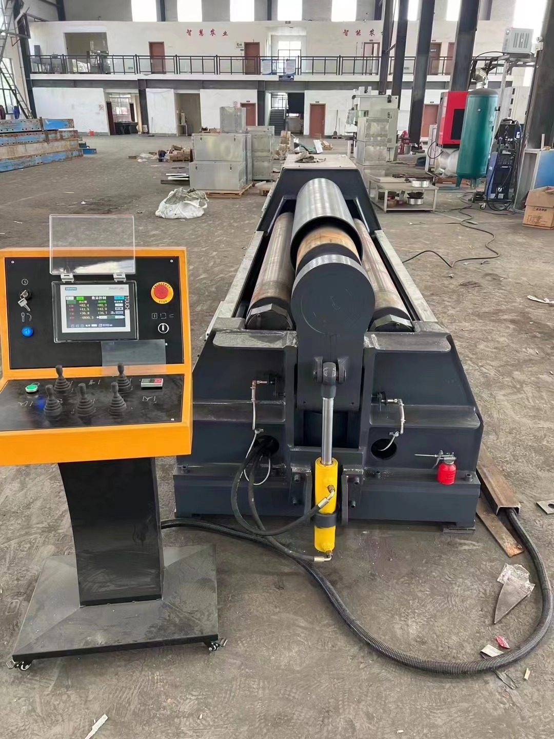 Plate rolling machine in a metal fabrication workshop